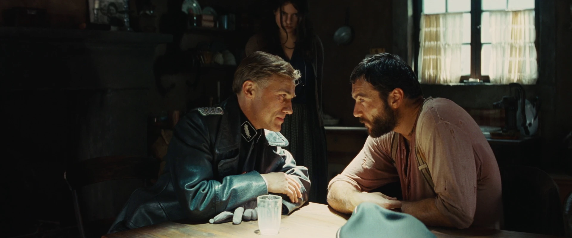 Image Hans Landa looks at Perrier LaPadite as Suzanne watches.jpg