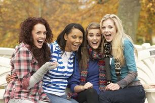 1239130-767114-group-of-four-teenage-girls-sitting-on-bench-in-autumn-park