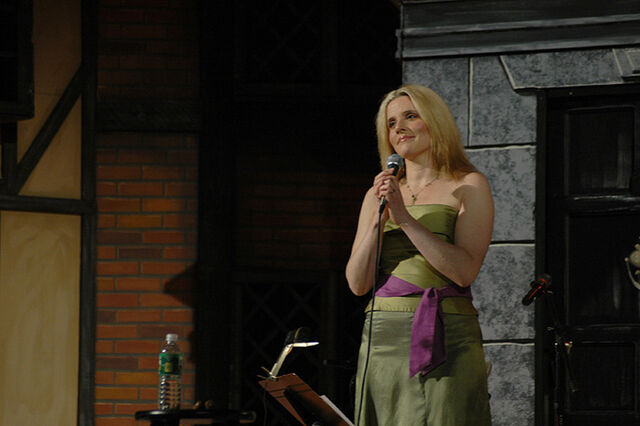 File:Méav smirks holding a microphone.jpg