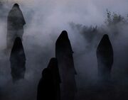 The hooded figures outside
