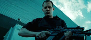 Russo holds a Carbine rifle at NSA facility