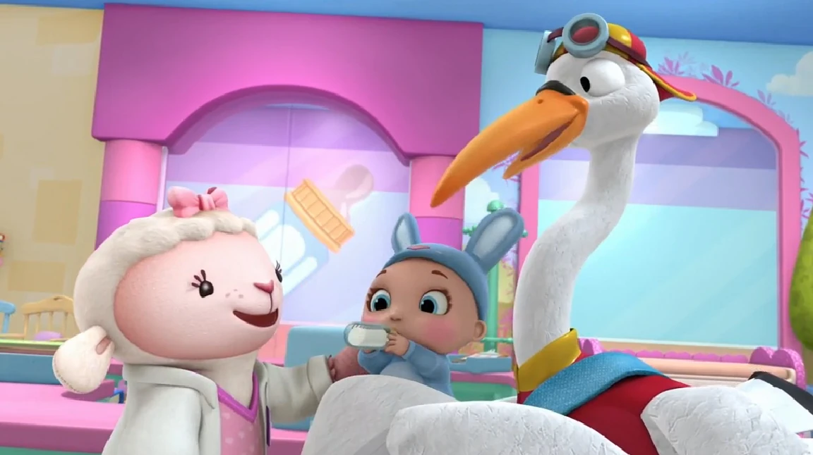 Image Lambie, baby in a bunny outfit and toy stork.jpg Doc