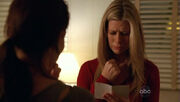 5x11-carole-holds-aaron-picture.jpg