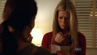 5x11-carole-holds-aaron-picture.jpg