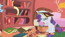 Rarity covering her head with a book S1E8.png