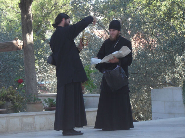 File:2 priests checking merchandise.jpg