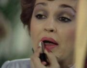 Tegan applying lipstick The Visitation