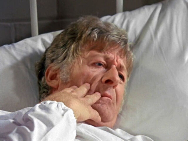 File:ThirdDoctor-ExaminingHisNewFace.jpg