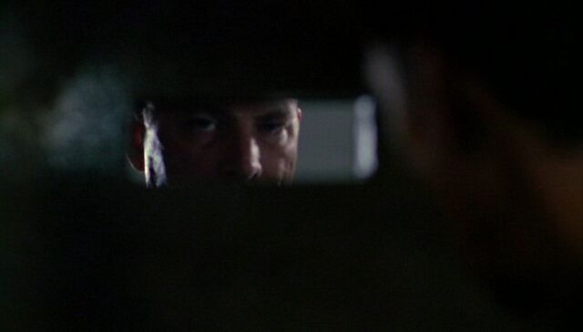 File:Black-Haired Man peering through slot.jpg