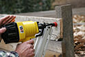 1280px-Using a nail gun